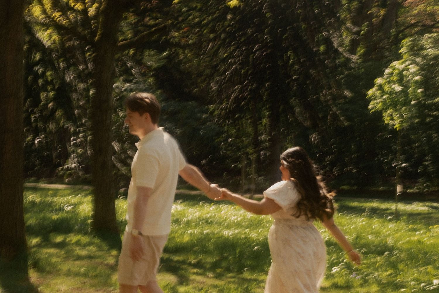 Couple walking hand in hand in golden light